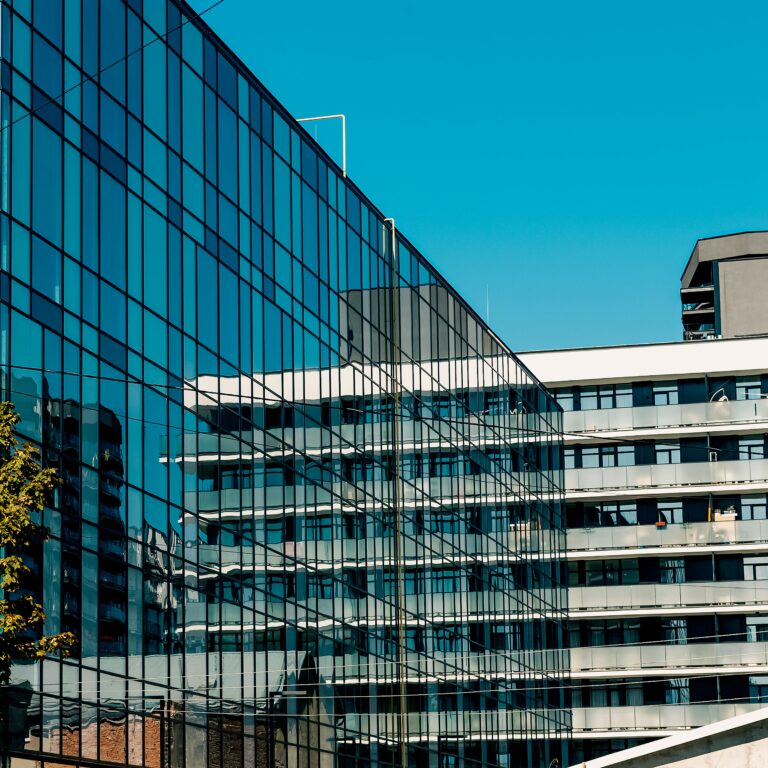 Reflective glass facade of a modern urban building showcasing contemporary architecture.
